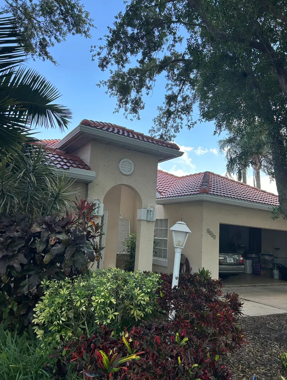 Tile-roof Florida home with seamless gutters by Samson Brothers
